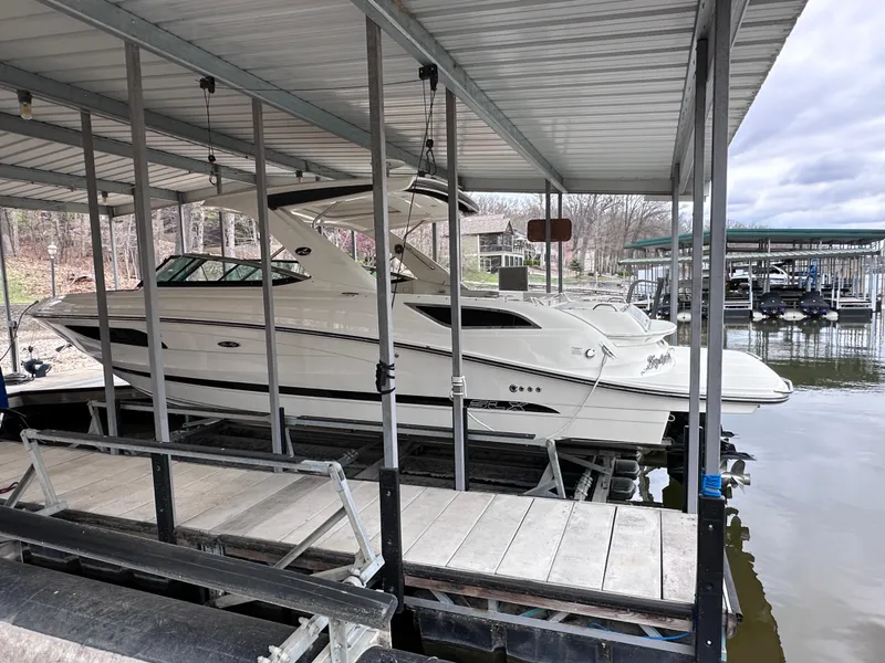 Slide: The Image of 2014 Sea Ray 350 SLX boat docked in a covered marina. - 2