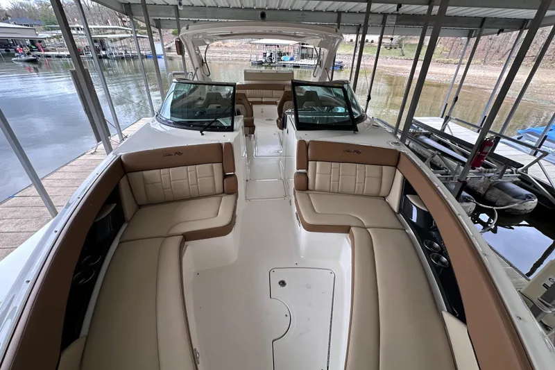 Slide: The Image of 2014 Sea Ray 350 SLX boat with spacious seating, docked in a covered marina. - 20