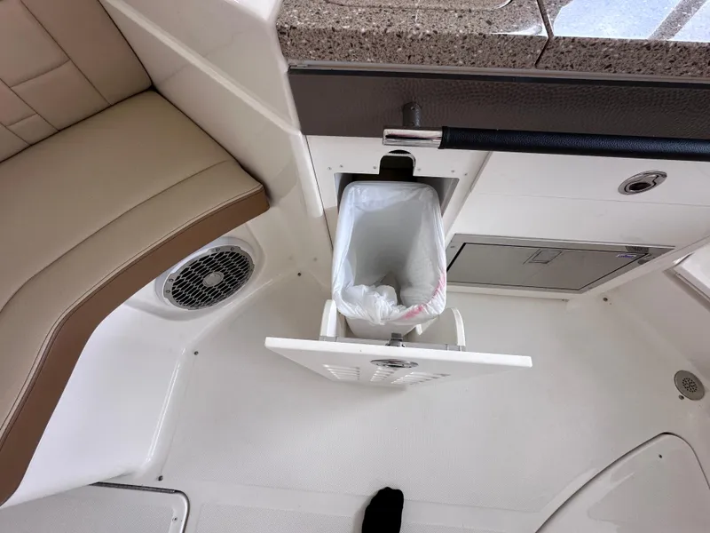Slide: The Image of Interior of 2014 Sea Ray 350 SLX with built-in trash compartment. - 25