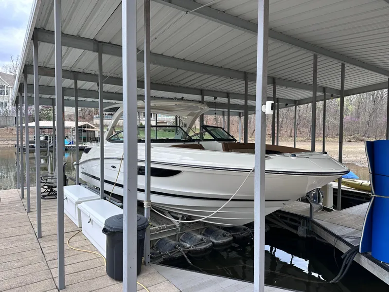 Slide: The Image of 2014 Sea Ray 350 SLX boat docked under covered marina. - 3