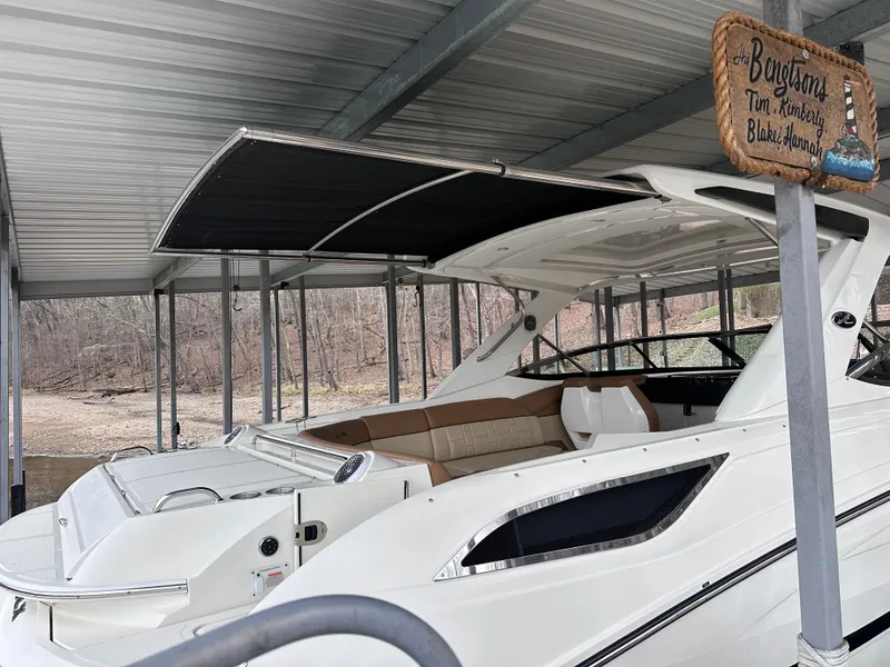 Slide: The Image of 2014 Sea Ray 350 SLX boat docked under a covered structure. - 30
