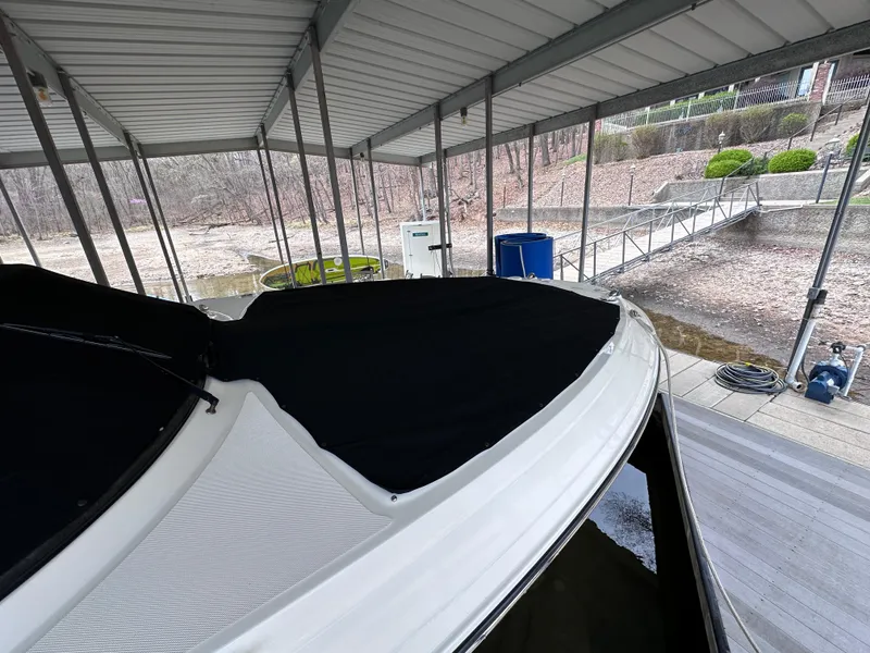 Slide: The Image of 2014 Sea Ray 350 SLX boat docked under a covered marina. - 31