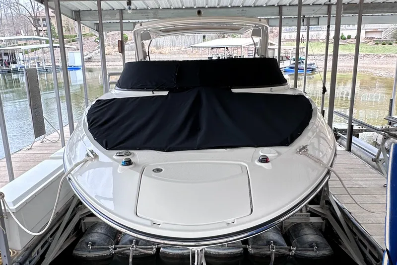 Slide: The Image of 2014 Sea Ray 350 SLX boat docked under a covered marina. - 33