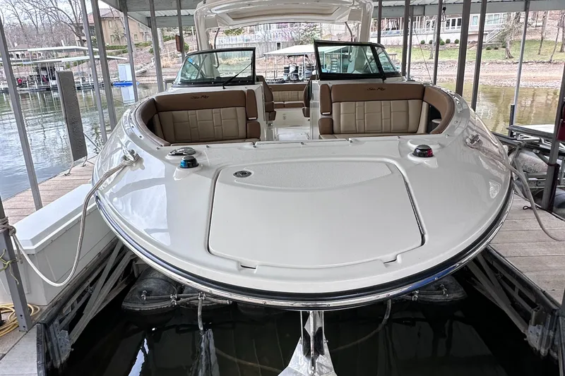 Slide: The Image of 2014 Sea Ray 350 SLX boat docked, showcasing spacious seating and sleek design. - 36