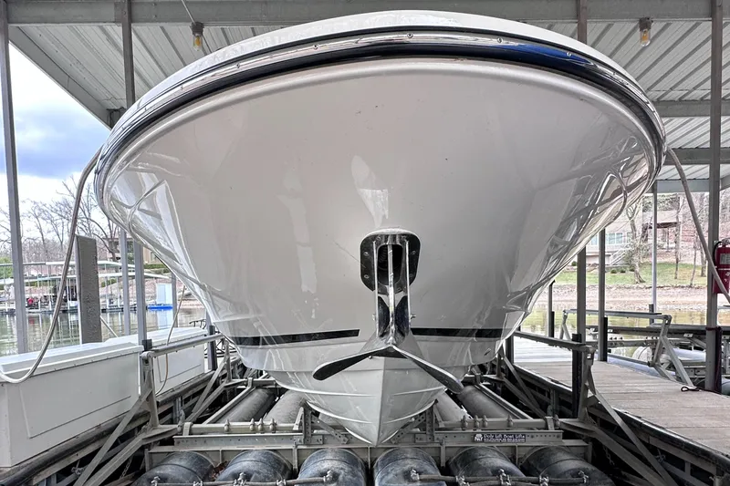 Slide: The Image of Front view of a 2014 Sea Ray 350 SLX boat docked in a covered marina. - 37