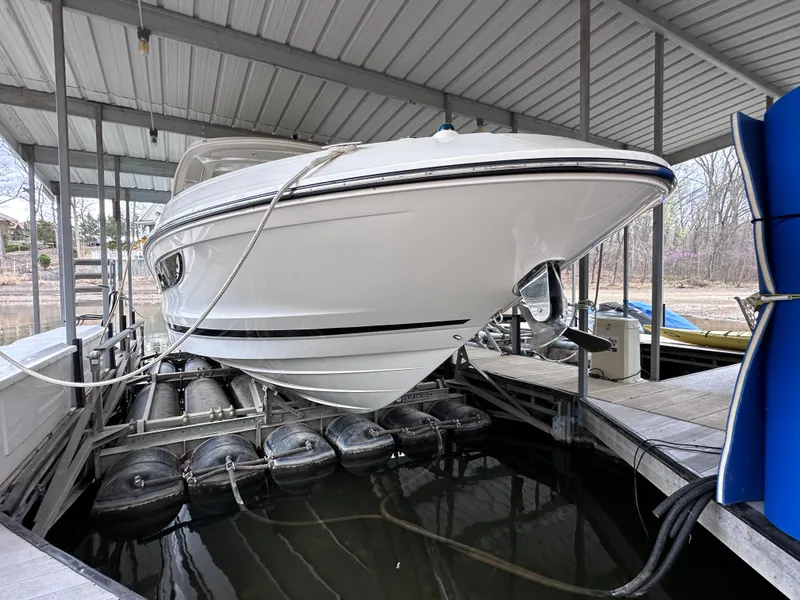 Slide: The Image of 2014 Sea Ray 350 SLX boat docked in covered marina, side view. - 4