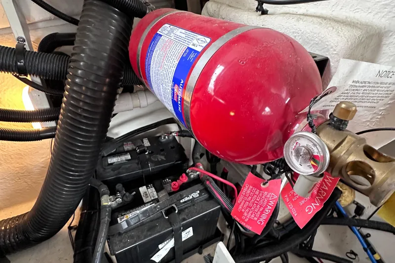 Slide: The Image of Fire extinguisher and batteries in 2014 Sea Ray 350 SLX engine compartment. - 42
