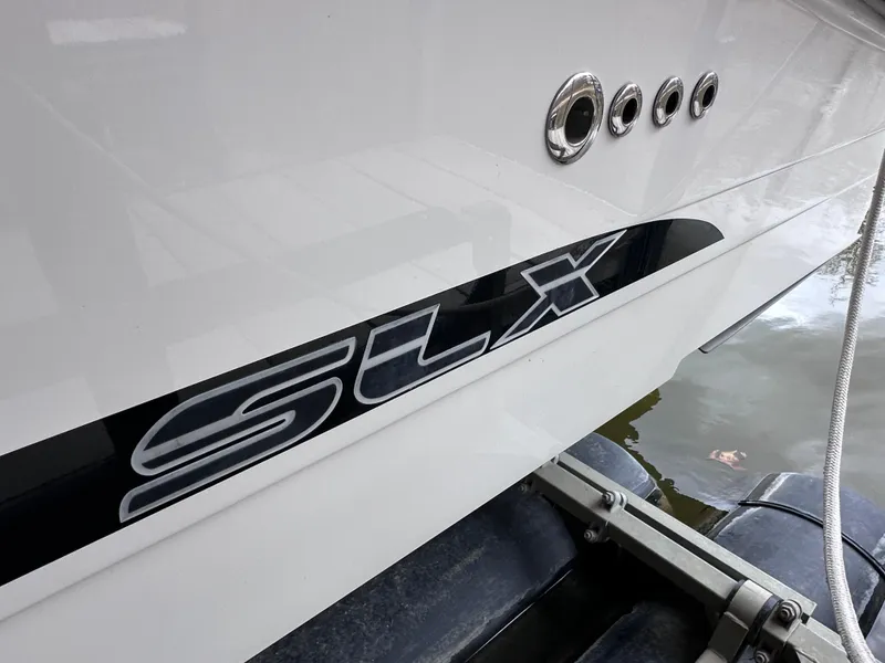 Slide: The Image of 2014 Sea Ray 350 SLX boat side view with logo and water reflection. - 44
