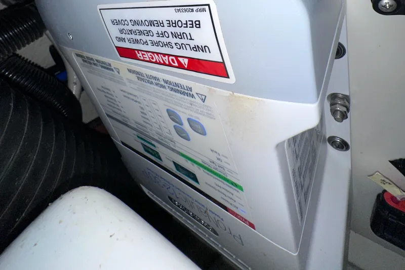 Slide: The Image of Engine compartment of a 2014 Sea Ray 350 SLX boat, showing warning labels and components. - 45