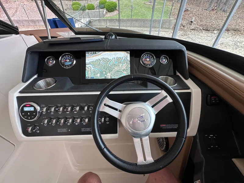 Slide: The Image of Dashboard of a 2014 Sea Ray 350 SLX boat with steering wheel and navigation display. - 5