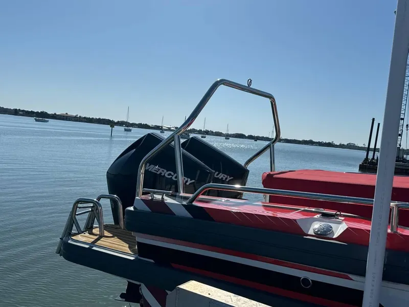 Slide: The Image of 2021 Axopar 28 CABIN boat with Mercury engine docked by the water. - 4