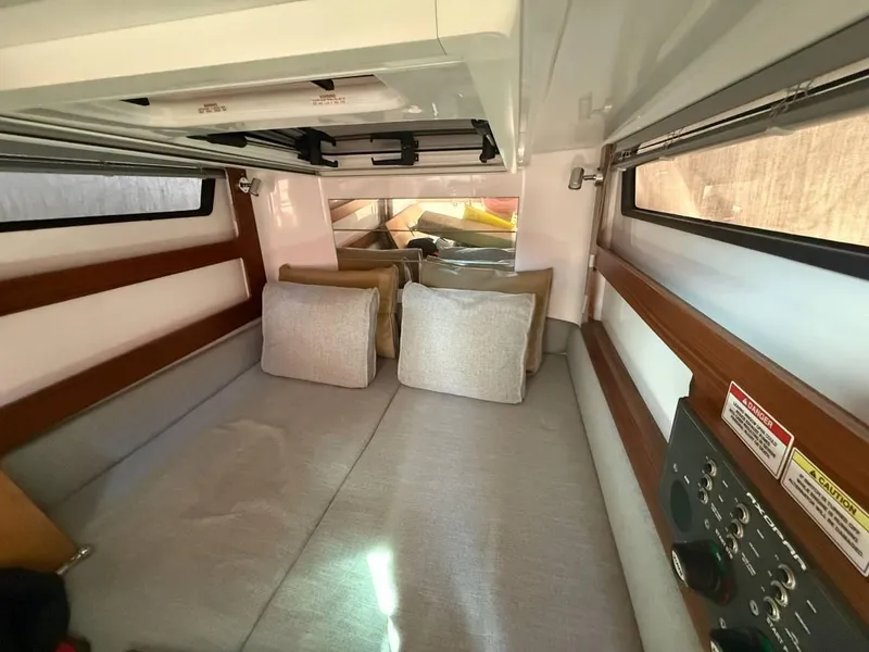 Slide: The Image of Interior cabin of 2021 Axopar 28 CABIN boat, featuring cozy seating and modern design. - 9