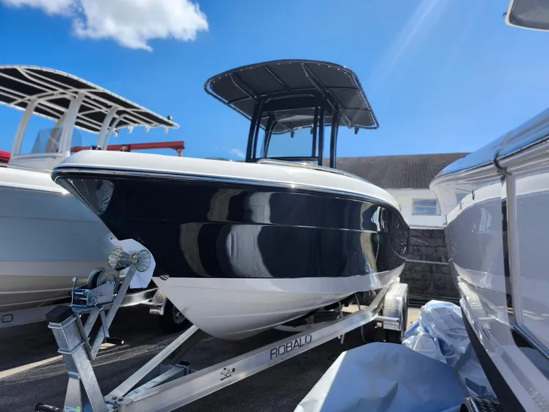 Slide: The Image of 2025 Robalo 222 Explorer boat on trailer under clear blue sky. - 3