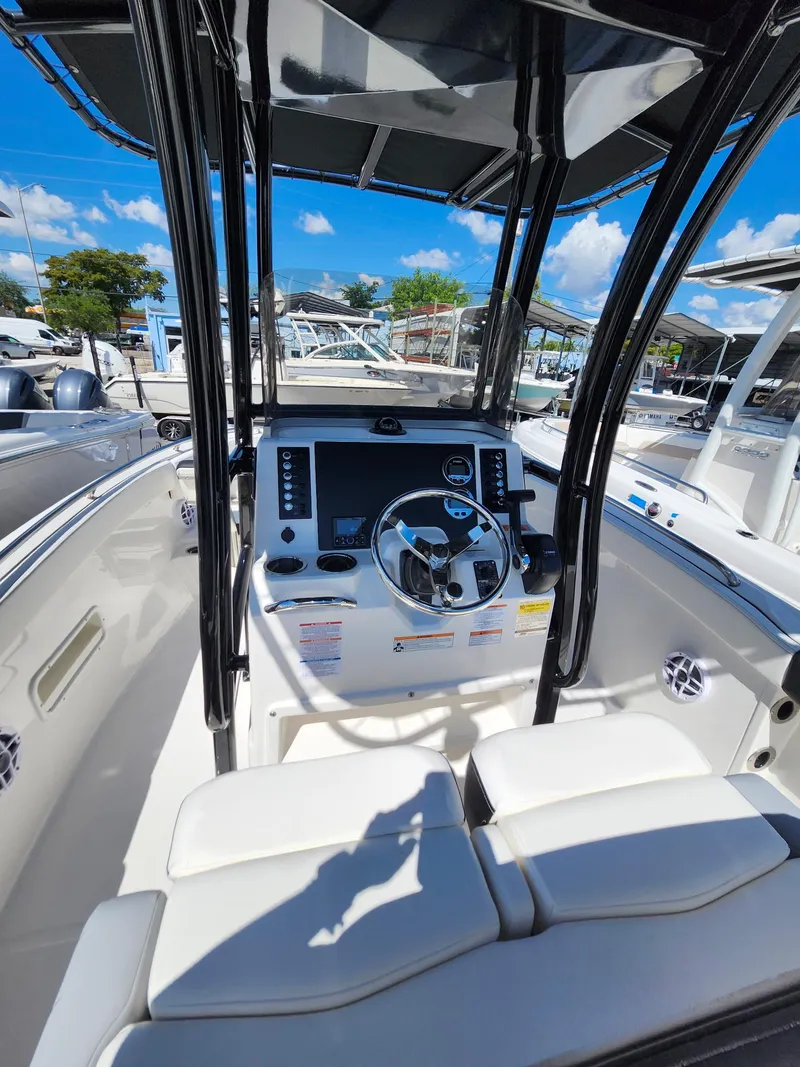 Slide: The Image of 2025 Robalo 222 Explorer boat cockpit with steering wheel and modern controls. - 5