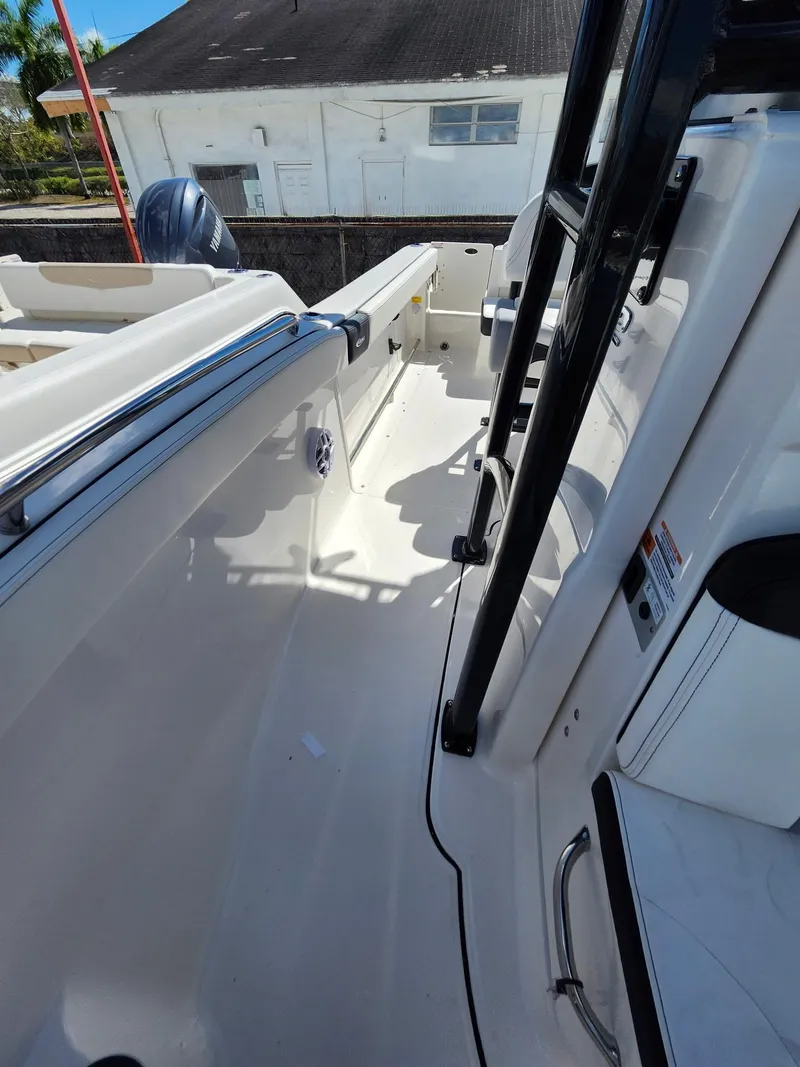 Slide: The Image of 2025 Robalo 222 Explorer boat interior with sleek white design and modern features. - 6