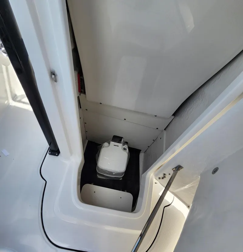 Slide: The Image of 2025 Robalo 222 Explorer boat interior with compact marine toilet. - 9