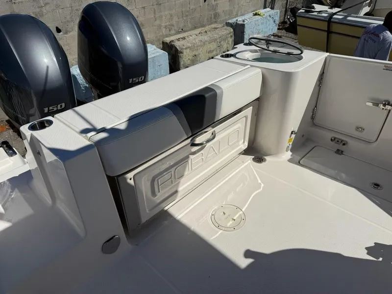 Slide: The Image of 2023 Robalo R250 boat deck with dual 150 engines, featuring storage and seating. - 10