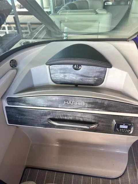 Slide: The Image of 2017 Harris Solstice 250 DC boat dashboard with storage compartment and control panel. - 7