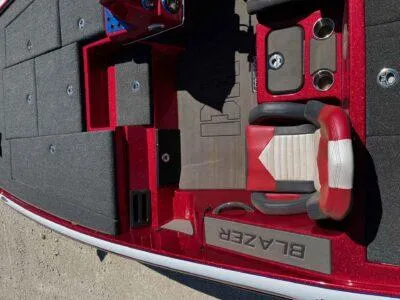 Slide: The Image of 2024 Blazer 650 Pro Tour boat interior with red and gray seating and deck layout. - 10