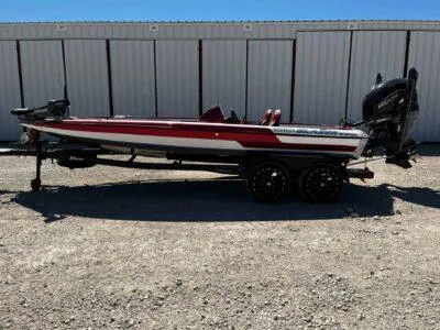Slide: The Image of 2024 Blazer 650 Pro Tour boat with red accents, parked on a trailer. - 4