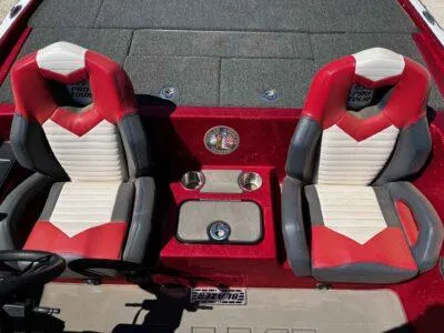 Slide: The Image of 2024 Blazer 650 Pro Tour boat seats, red and white design, with cup holders. - 7