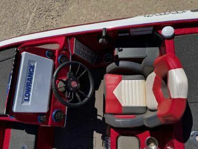 Slide: The Image of 2024 Blazer 650 Pro Tour boat interior with red and white seating and Lowrance electronics. - 8