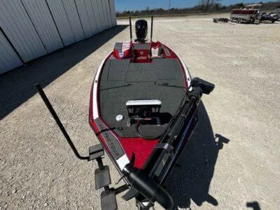 Slide: The Image of 2024 Blazer 650 Pro Tour boat on gravel, featuring a sleek red and black design. - 9