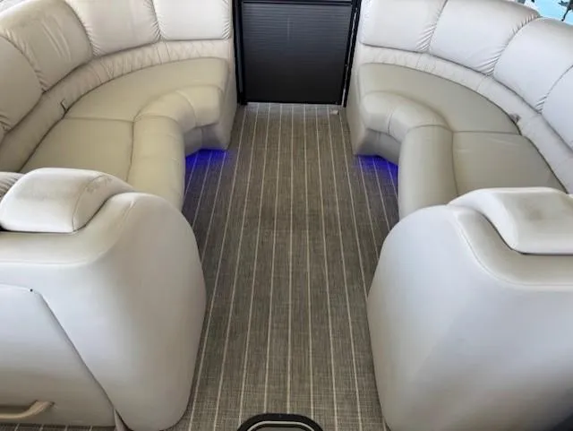 Slide: The Image of 2017 Harris Solstice DC 250 boat interior with plush seating and ambient lighting. - 4