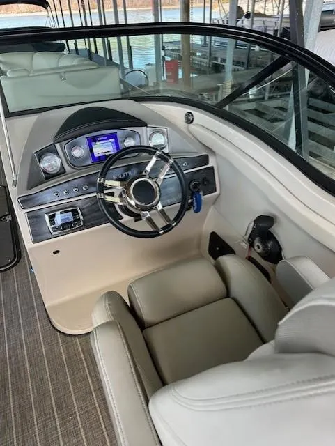 Slide: The Image of 2017 Harris Solstice DC 250 boat interior with steering wheel and dashboard controls. - 9
