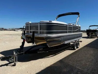 Slide: The Image of 2025 SunCatcher Select 322RC pontoon boat on trailer, parked outdoors under clear blue sky. - 3