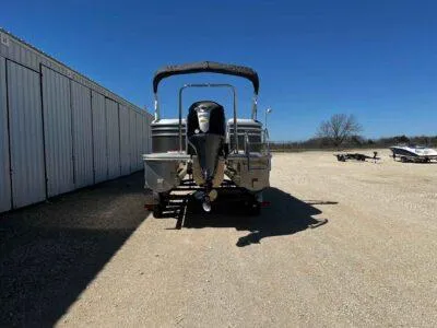 Slide: The Image of 2025 SunCatcher Select 322RC pontoon boat parked outdoors on gravel. - 4