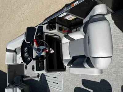 Slide: The Image of 2025 SunCatcher Select 322RC boat interior with steering wheel and seating. - 6