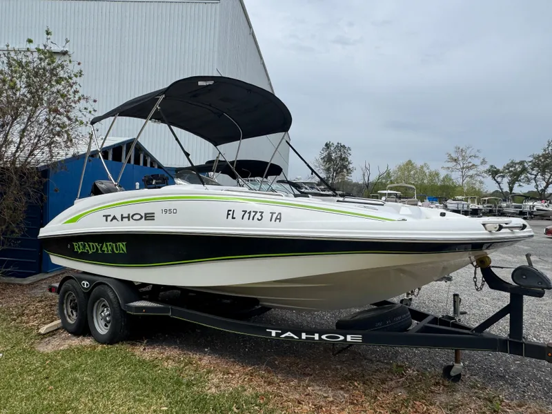Slide: The Image of Tahoe 1950 boat on trailer, 2018 model, parked outdoors near a building. - 11