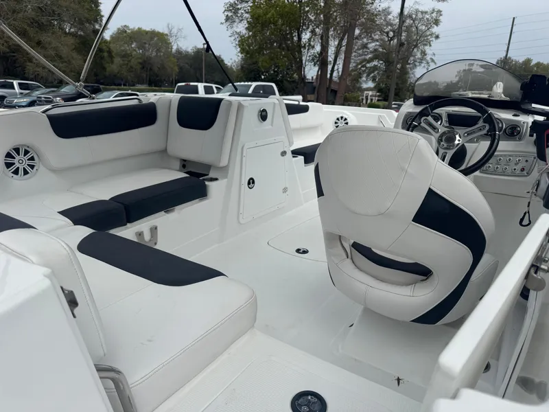 Slide: The Image of Interior of a 2018 Tahoe 1950 boat with white and black seating. - 12
