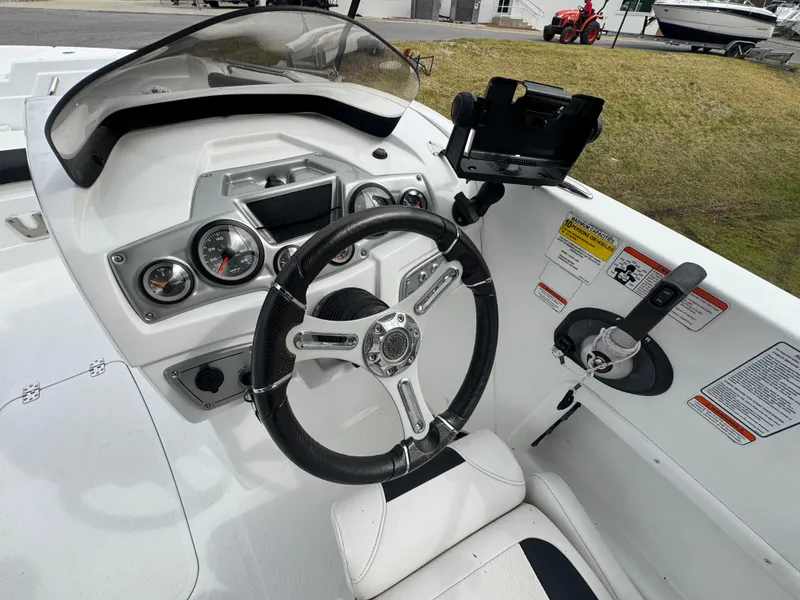 Slide: The Image of Steering console of a 2018 Tahoe 1950 boat with gauges and controls. - 5