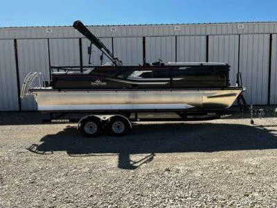 Slide: The Image of 2025 SunCatcher Select 322SS pontoon boat on trailer, parked outdoors. - 0