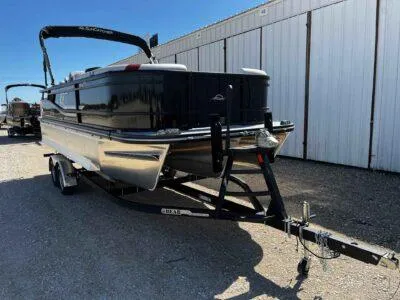 Slide: The Image of 2025 SunCatcher Select 322SS pontoon boat on trailer, parked outdoors. - 1