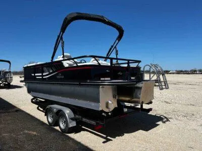Slide: The Image of 2025 SunCatcher Select 322SS pontoon boat on trailer under clear blue sky. - 3