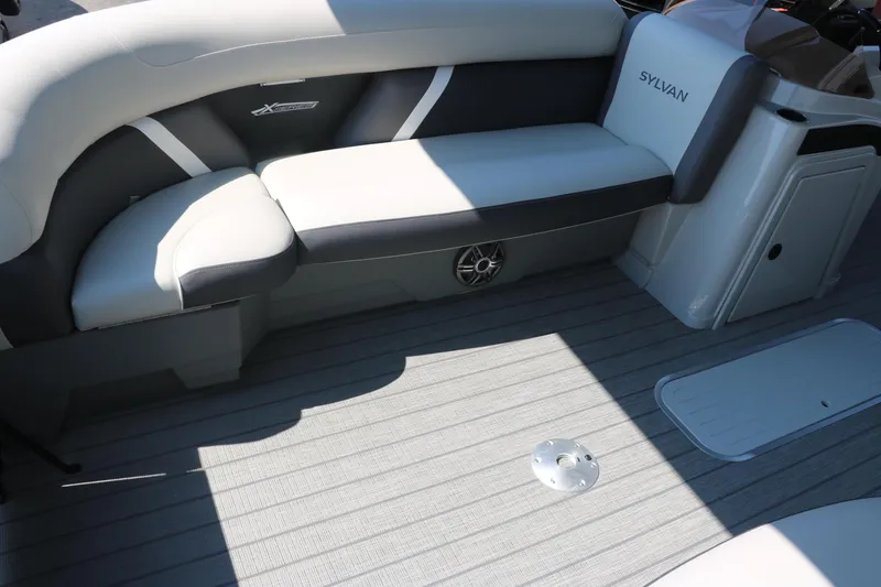Slide: The Image of 2025 Sylvan Mirage X3 Party Fish boat interior with cushioned seating and sleek design. - 22