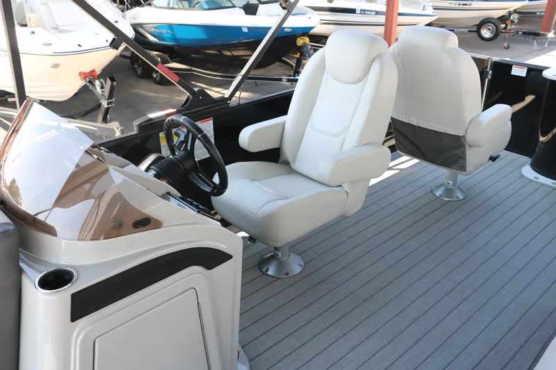 Slide: The Image of 2025 Sylvan Mirage X3 Party Fish boat interior with plush seating and modern helm. - 24