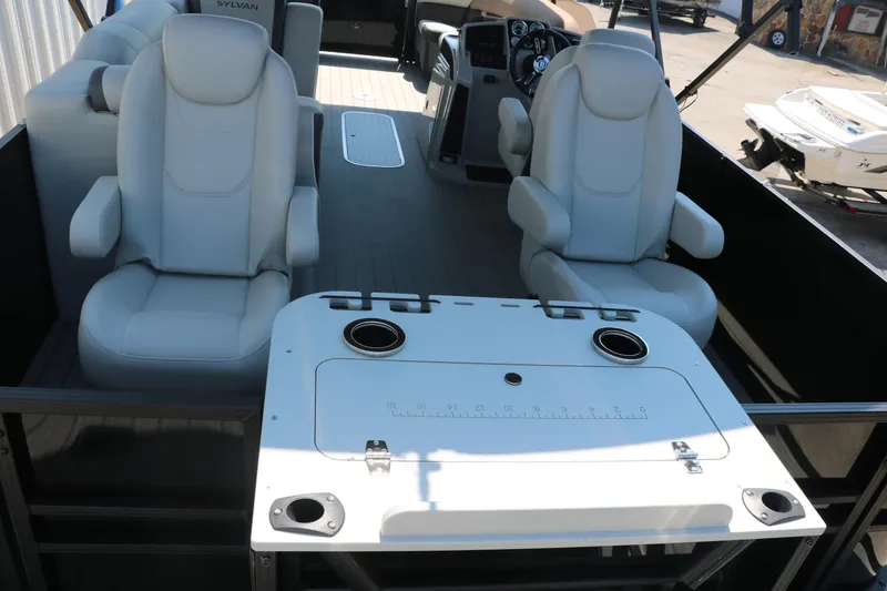 Slide: The Image of 2025 Sylvan Mirage X3 Party Fish interior with plush seating and fishing station. - 28