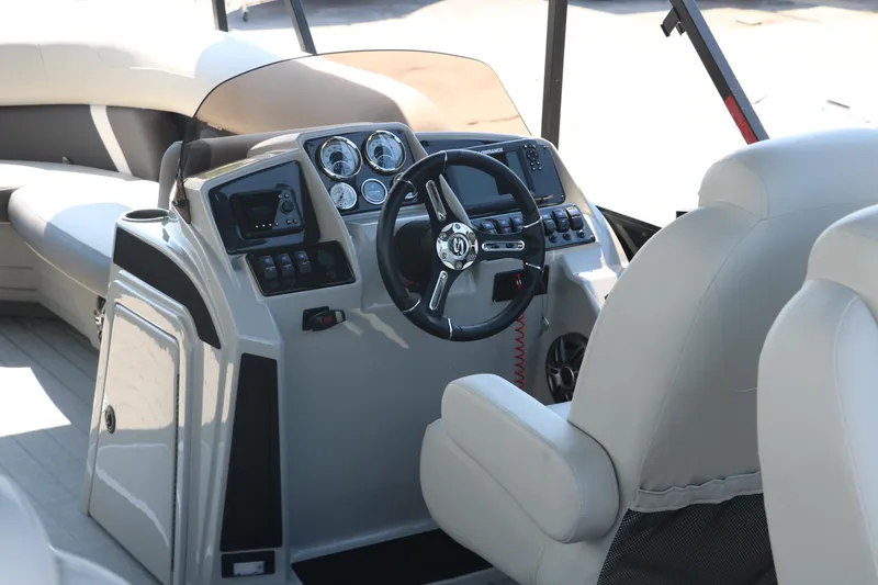 Slide: The Image of 2025 Sylvan Mirage X3 Party Fish boat interior with steering console and seating. - 29