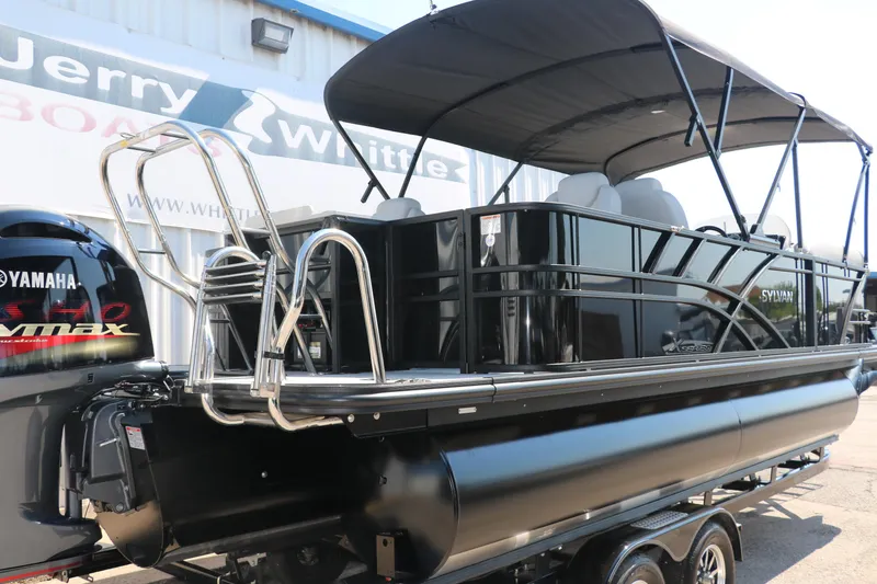 Slide: The Image of 2025 Sylvan Mirage X3 Party Fish pontoon boat with Yamaha engine, parked outdoors. - 3