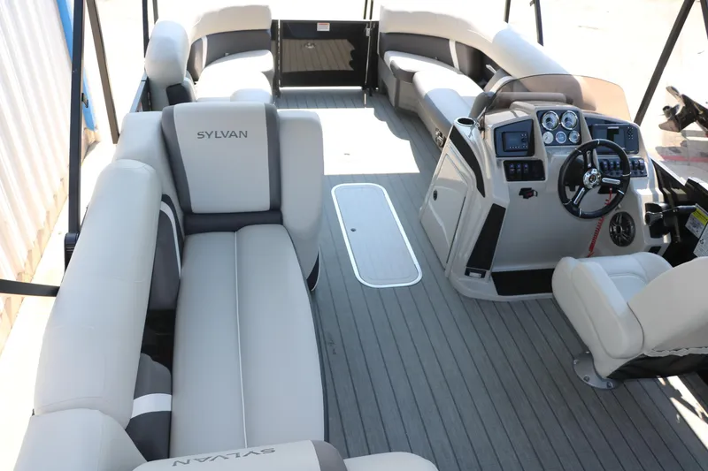 Slide: The Image of 2025 Sylvan Mirage X3 Party Fish pontoon boat interior with plush seating and modern dashboard. - 31