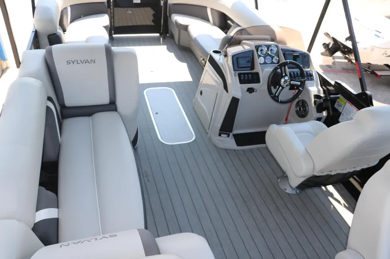 Slide: The Image of 2025 Sylvan Mirage X3 Party Fish pontoon boat interior with plush seating and modern dashboard. - 32