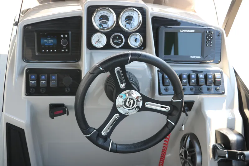 Slide: The Image of 2025 Sylvan Mirage X3 Party Fish dashboard with steering wheel, gauges, and navigation system. - 35