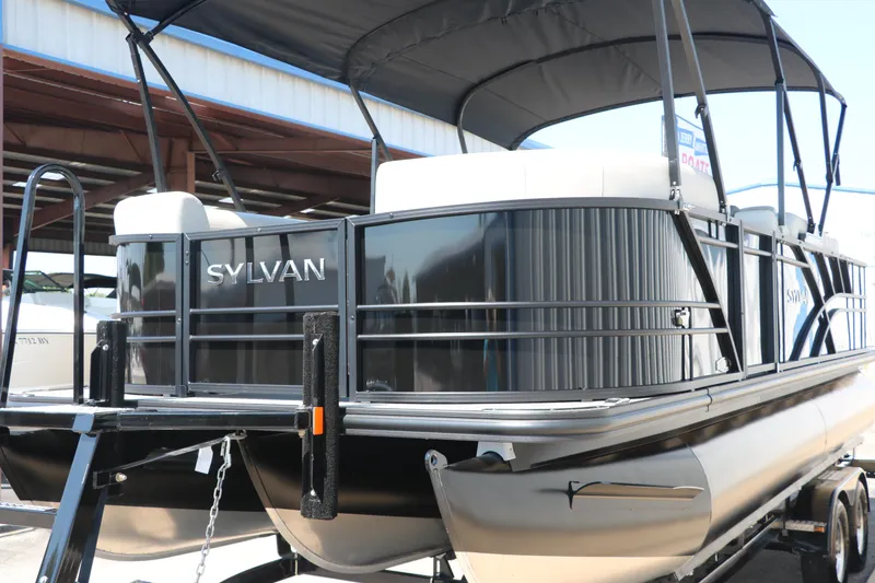 Slide: The Image of 2025 Sylvan Mirage X3 Party Fish pontoon boat with canopy, docked outdoors. - 9