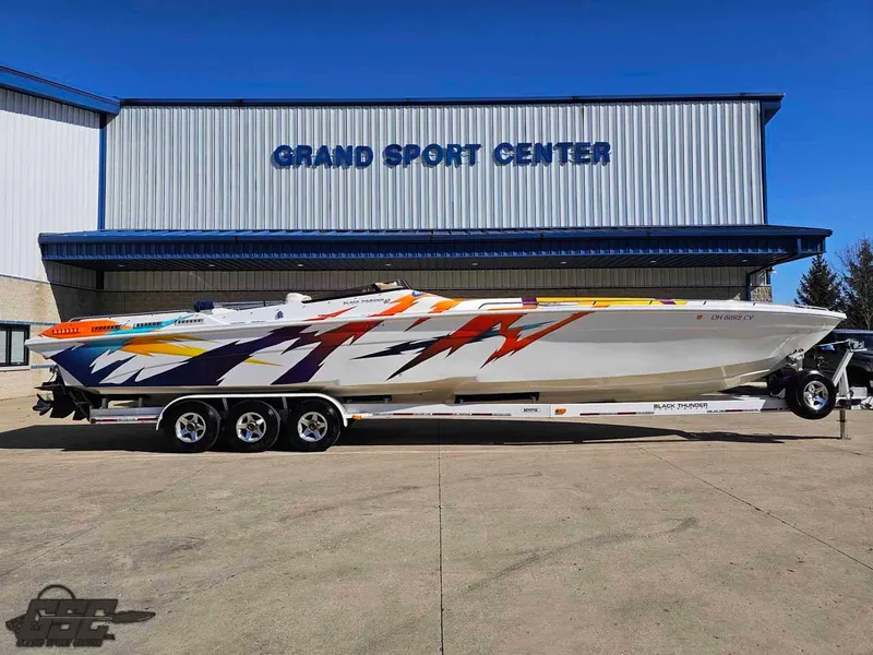 Slide: The Image of 2001 Black Thunder 43 GT Flat Deck boat with vibrant graphics at Grand Sport Center. - 1