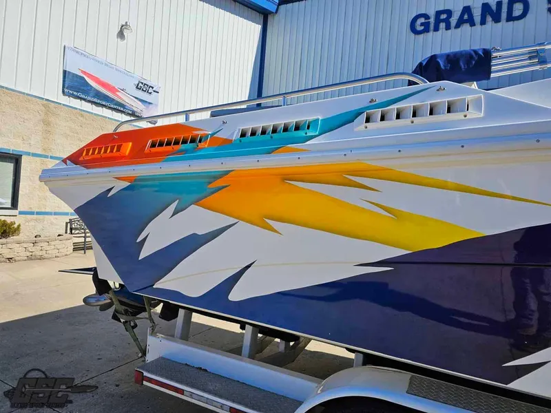 Slide: The Image of 2001 Black Thunder 43 GT Flat Deck boat with vibrant, colorful graphics on the side. - 10