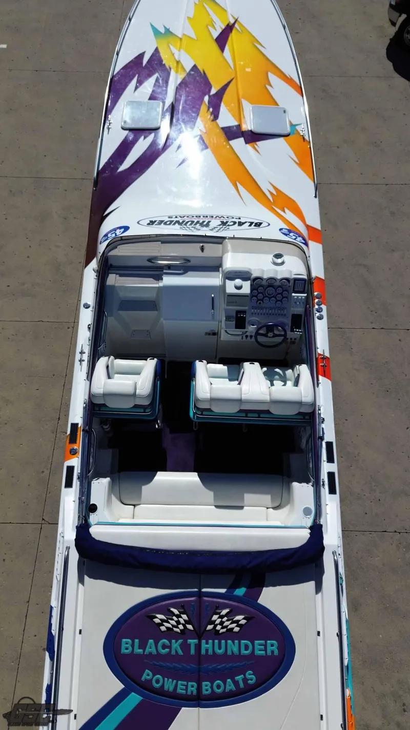 Slide: The Image of 2001 Black Thunder 43 GT Flat Deck powerboat with vibrant graphics and spacious seating. - 21
